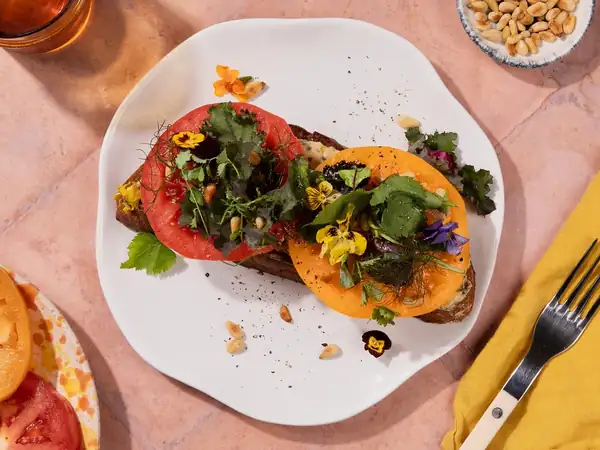 Tomato sandwich with anchovy butter and wild herb salad