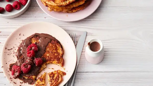 Protein pancakes with raspberries and chocolate sauce
