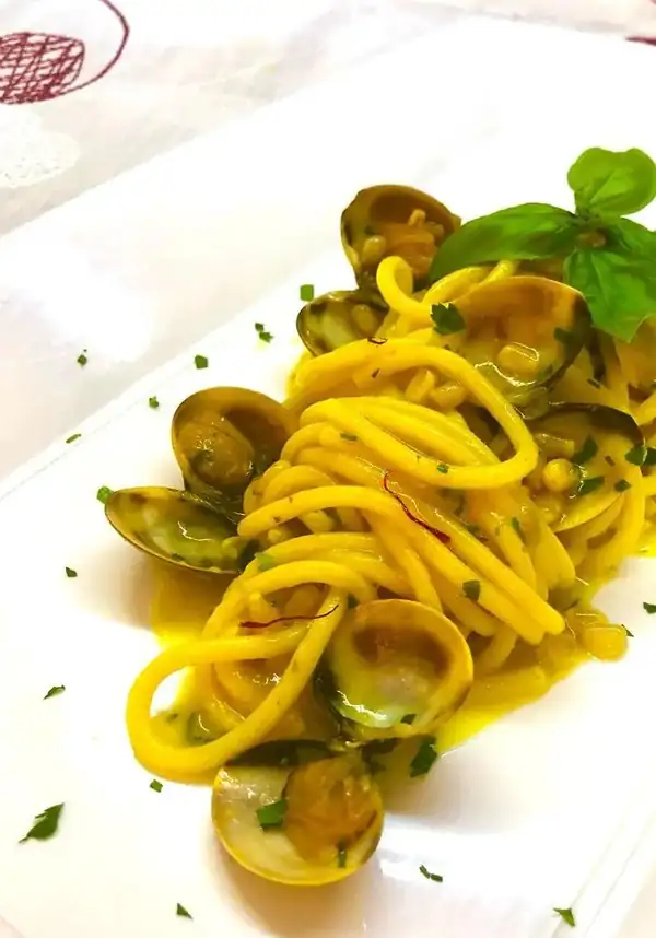 Spaghetti with clams, saffron, and pine nuts