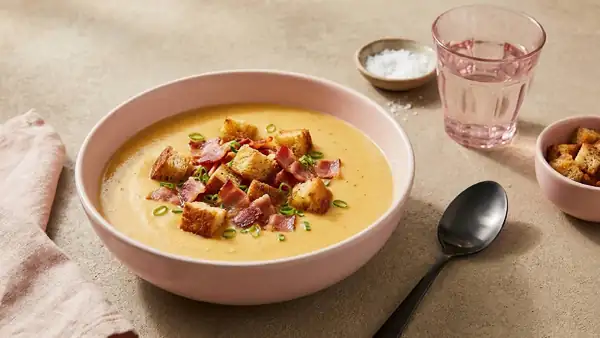 Hearty cheese and beer soup with bacon and croutons