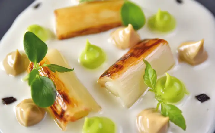 Roasted leek with cod pil pil, mustard and black garlic