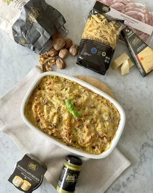 BAKED PENNE WITH PISTACHIO BÉCHAMEL, COPPATA PANCETTA, SMOKED BURRATA AND WALNUTS