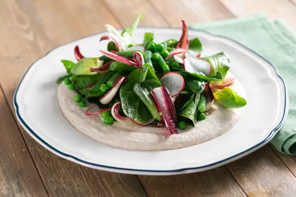 Spring vegetables on cannellini bean puree