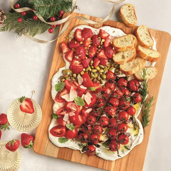 Whipped goat cheese board with sun-dried tomatoes and strawberries