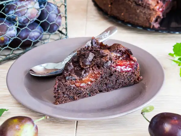 Intensely chocolatey cake with plums