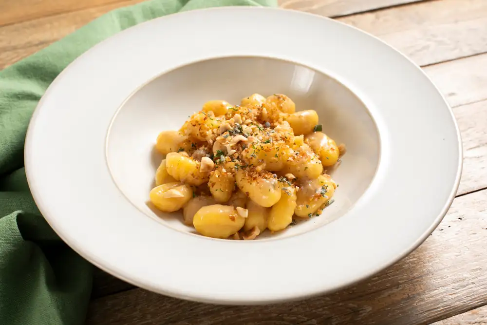 Gluten-free gnocchi with butter, anchovies and herbs